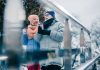 Preparing for Winter in Australia – Tips to keep elders safe Cheerful elderly people walking with hot chocolate in paper cups and smiling while enjoying winter day outdoors