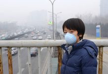 How Air Pollution Affects Health of Children Asian child protects himself against air pollution by wearing mouth mask